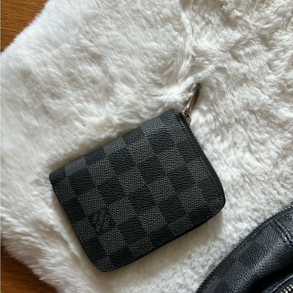 Louis Vuitton Daimler zip wallet and Josh backpack.
